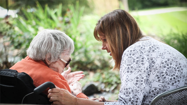 Volunteer talking with an older woman