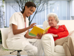 A volunteer reading to an older woman